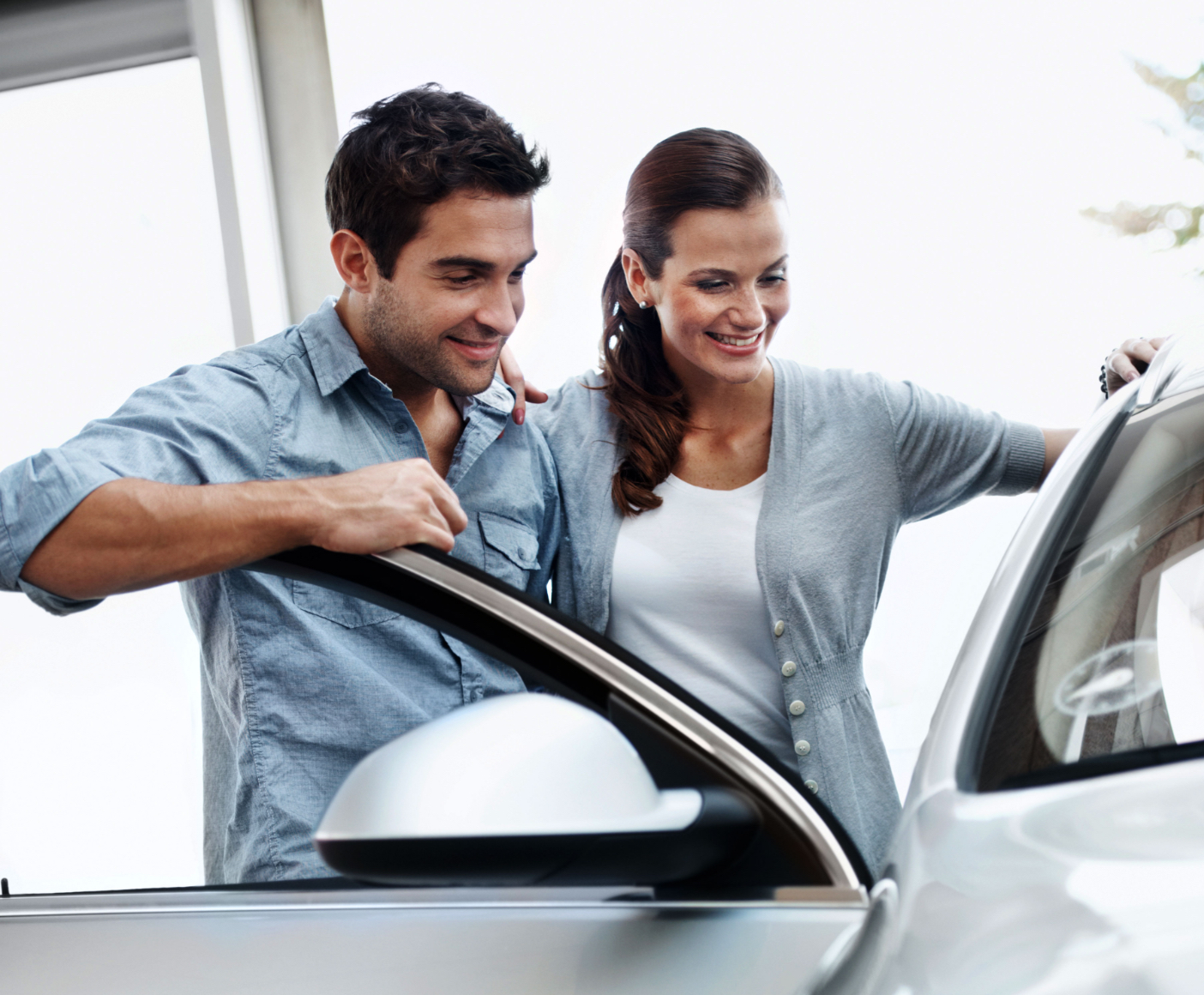 Young couple looking at a car